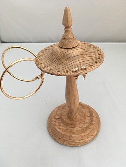 An earring stand in oak