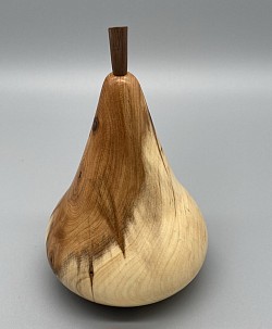 A pear turned from yew wood.